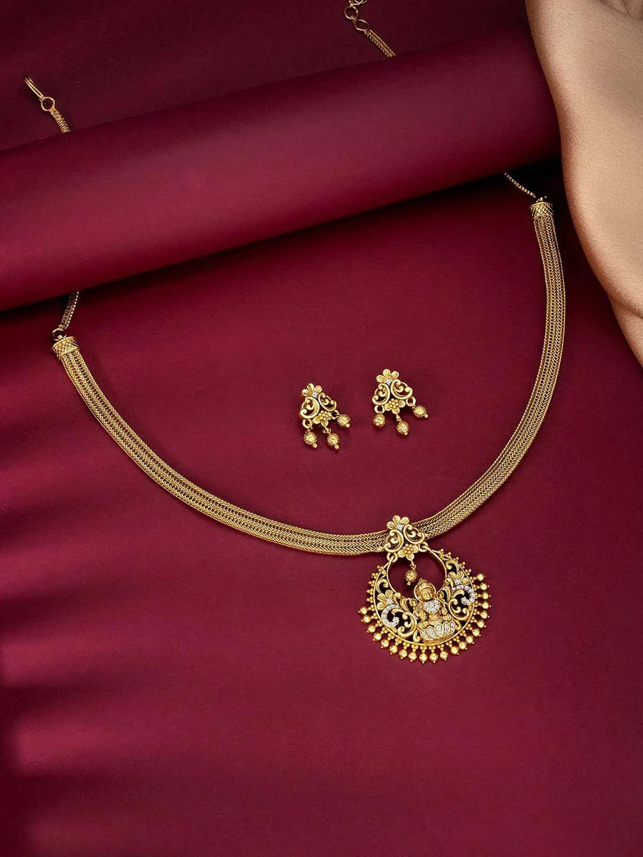 Radiant Elegance Golden Necklace Set. A golden necklace set with intricate designs, consisting of necklace and matching earrings.
