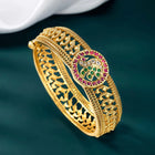 Traditional Kada with Intricate Design. Gold plated with green, white & purple stones. It has detailed design with screw opening. Best temple jewellery.