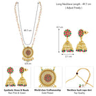 A traditional Indian necklace set with gold-colored metalwork and synthetic stones, accompanied by matching earrings, displayed on a white fabric surface.