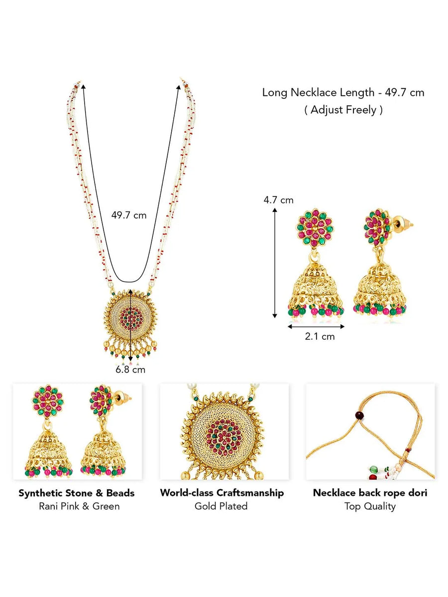 A traditional Indian necklace set with gold-colored metalwork and synthetic stones, accompanied by matching earrings, displayed on a white fabric surface.