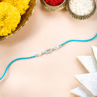 Close-up of Sterling Silver Rakhi Weave Design Band featuring teal green thread, nan work, and rhodium plating – ideal for Raksha Bandhan | Peora

